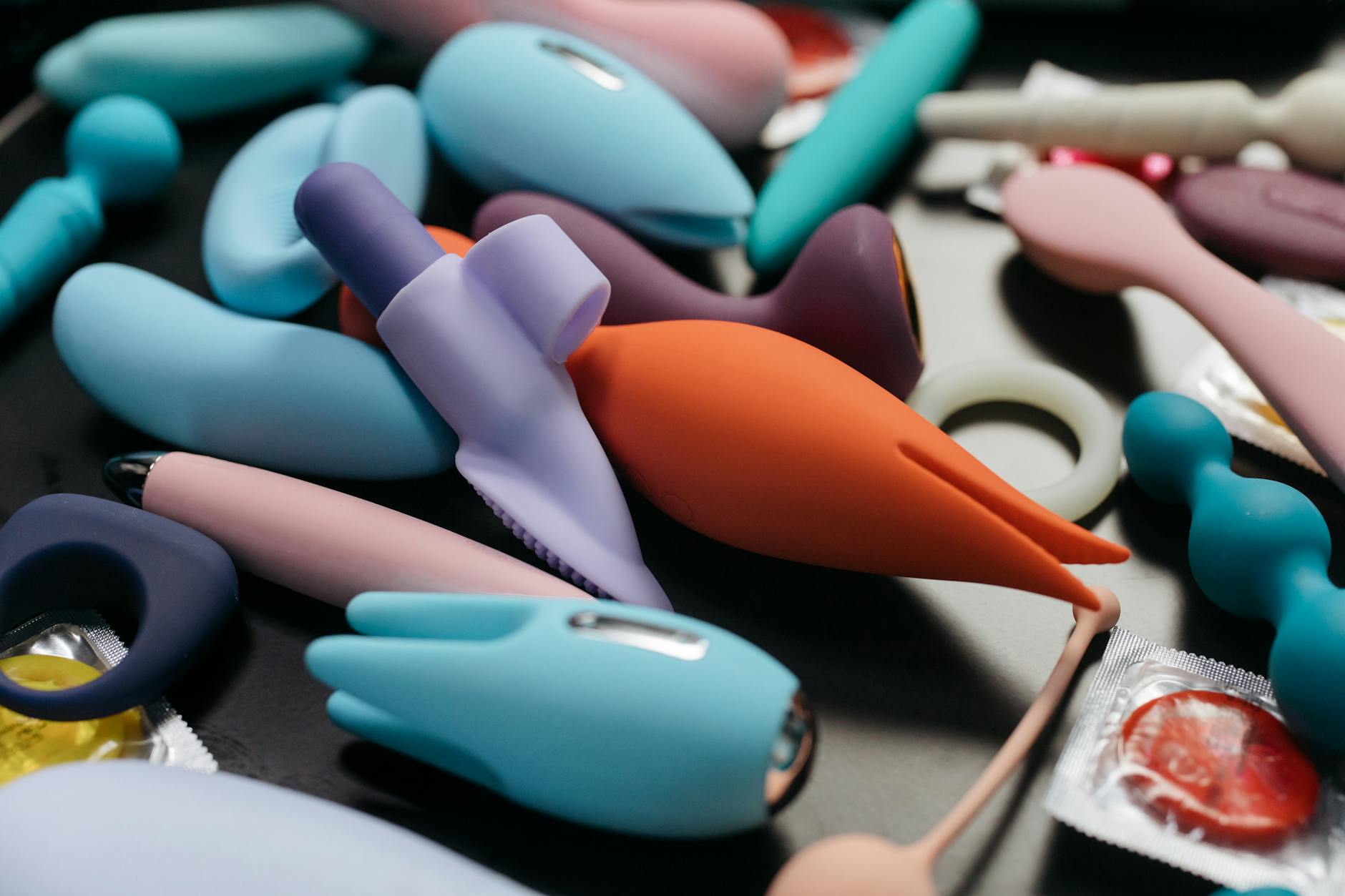 An array of vibrant lemon and pastel-colored adult toys including clitoral vibrators and pleasure devices