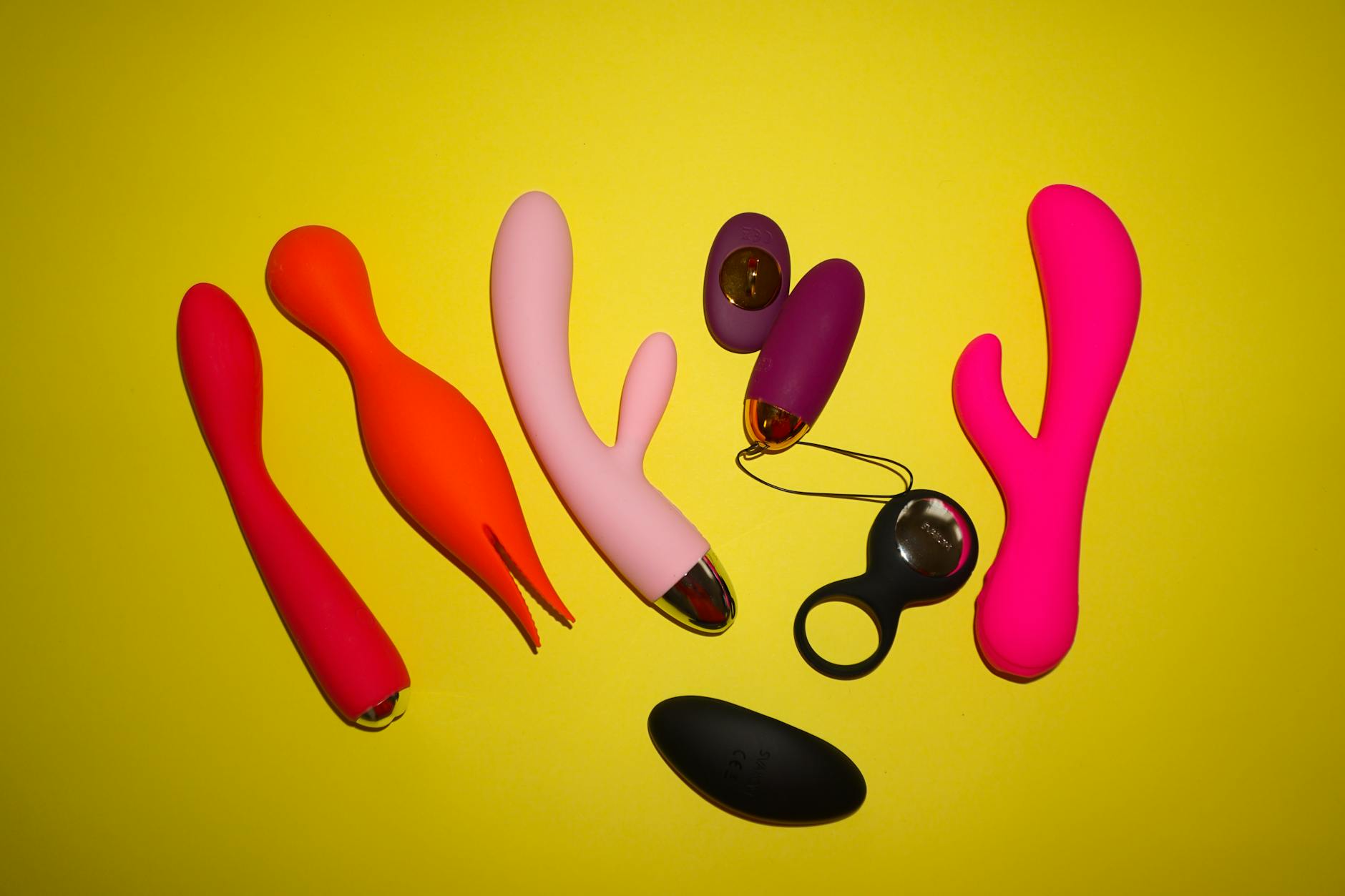 Woman contemplating pleasure and sensation recovery with blue and pink vibrators